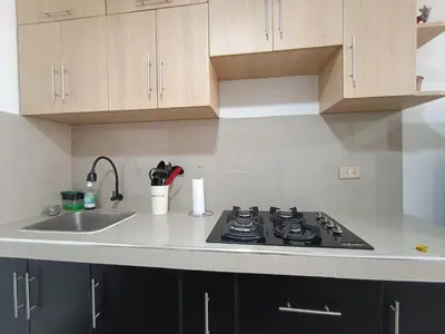 a kitchen with a stove and a sink at Acogedor APT a 20 min Aeropuerto in Lima