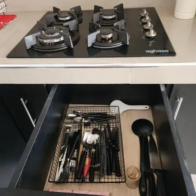 a kitchen counter with a stove top with utensils at Acogedor APT a 20 min Aeropuerto in Lima