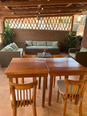 a wooden table and chairs in a living room at San Miguel, lindo depa, 3 camas, internet y cable in Lima