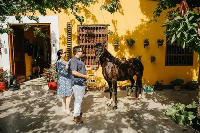 a man and a woman standing next to a horse at Serenity Lodge in Ica