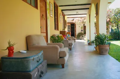a hallway with couches and chairs in a house at Serenity Lodge in Ica