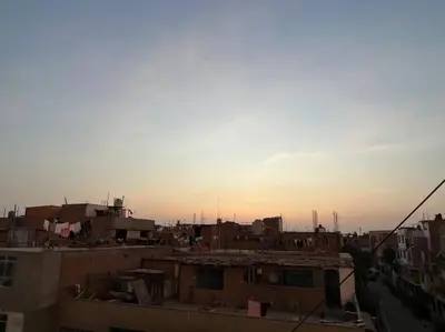 a view of a city at sunset with buildings at Espacio para ti y tu familia in Lima