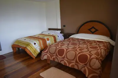two beds sitting next to each other in a room at CasaNostra Choquequirao in Cachora
