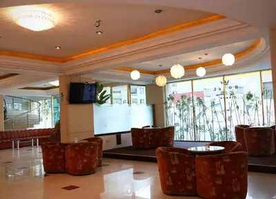 a lobby with chairs and a projection screen at Hotel Princesa in Lima
