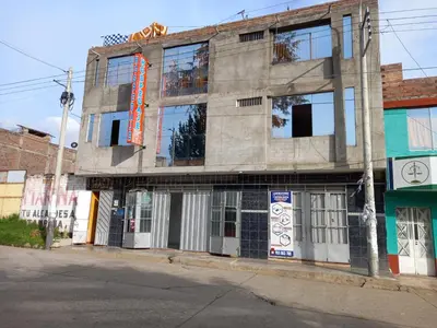 a building on the corner of a street at Hospedaje TOSCANO SUITES in Huancayo