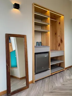 a living room with a tv and a mirror at Kauhuhu Casa Hotel in San Bartolo