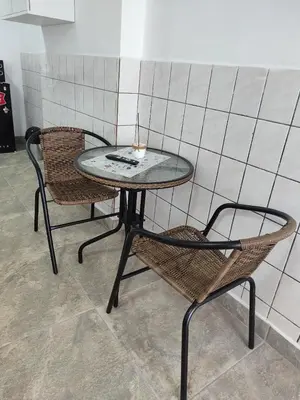 two chairs and a table and a table and chairs at Sanbar House in San Bartolo
