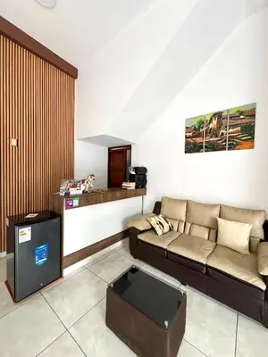 a living room with a couch and a table at Golden Paris Hotel 
