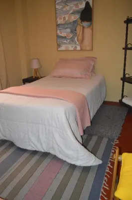a bedroom with a large bed with a blanket at Lima Guest Room House in Lima