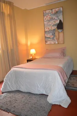 a bedroom with a large white bed in a room at Lima Guest Room House in Lima