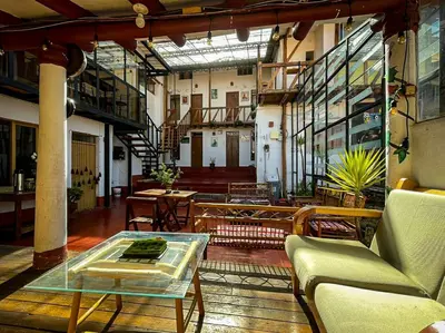 a living room with a glass table and chairs at Casa Cusco guest house in Cusco