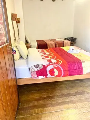 a small child laying on a bed in a room at Casa Cusco guest house in Cusco
