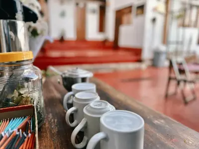 a row of coffee cups sitting on a table at Casa Cusco guest house in Cusco