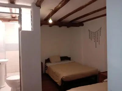 a bedroom with a bed and a toilet in a room at Casa Cusco guest house in Cusco