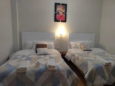 two beds sitting next to each other in a room at CASA DE MELISSA in Ollantaytambo