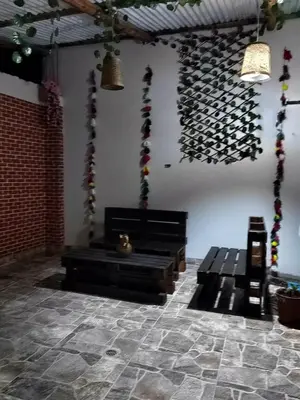 a room with a bunch of wine bottles on the wall at CASA DE MELISSA in Ollantaytambo