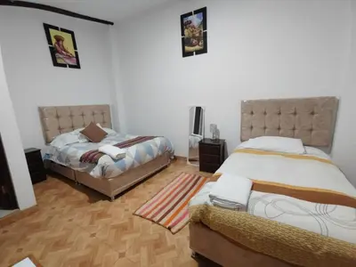two beds in a room with two beds sidx sidx sidx at CASA DE MELISSA in Ollantaytambo