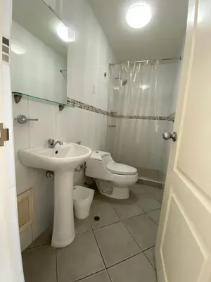 a white bathroom with a sink and a toilet at The Point Miraflores, Lima in Lima