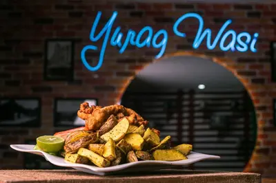 a plate of food with chicken and vegetables on a table at YURAQ WASI Hotel/Restobar in Huánuco