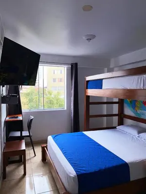 a bedroom with a bunk bed and a television at Magdalen House in Lima