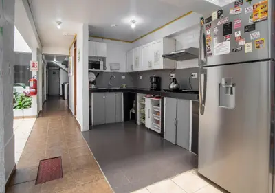 a kitchen with a stainless steel refrigerator at Magdalen House in Lima