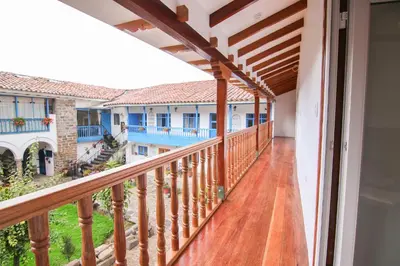a balcony with wooden railings in a house at QORI, apartamento nuevo Centro Histórico de Cusco, Cuesta San Blas 561 in Cusco