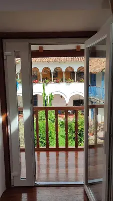 a sliding glass door with a view of a balcony at QORI, apartamento nuevo Centro Histórico de Cusco, Cuesta San Blas 561 in Cusco