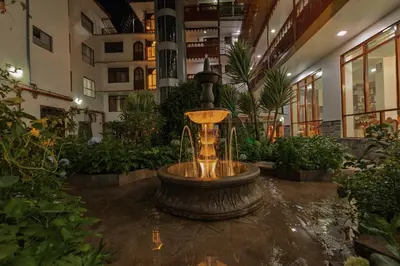 a fountain in the middle of a building with plants at Quechua Hotel Cusco in Cusco