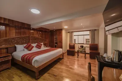 a bedroom with a bed and a desk in a room at Quechua Hotel Cusco in Cusco
