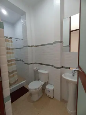 a bathroom with a toilet and a sink at CARDOS HOSTAL in Pisco