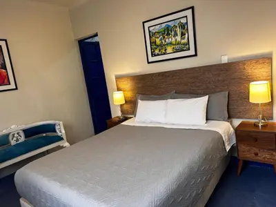 a hotel room with a bed and two lamps at yuraqtampu- Pardo in Cusco