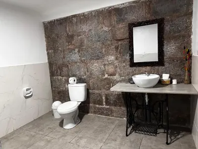 a bathroom with a sink and a toilet and a mirror at yuraqtampu- Pardo in Cusco