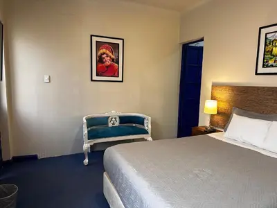 a hotel room with a bed and a chair at yuraqtampu- Pardo in Cusco