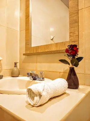 a bathroom with a sink and a towel on a counter at Zisary's House Apartment in Cusco