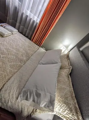 a bed in a bedroom next to a window at Zisary's House Apartment in Cusco