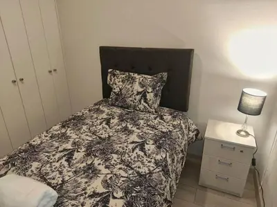 a bedroom with a bed with a black and white comforter at Met Moderno Departamento in Lima