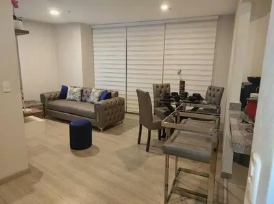 a living room with a couch and a table at Met Moderno Departamento in Lima