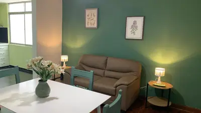 a living room with a couch and a table at Lindo depa san miguel, 3camas, wifi, terraza. in Lima
