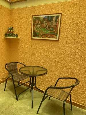 a table and two chairs next to a wall with a picture at Lindo depa san miguel, 3camas, wifi, terraza. in Lima