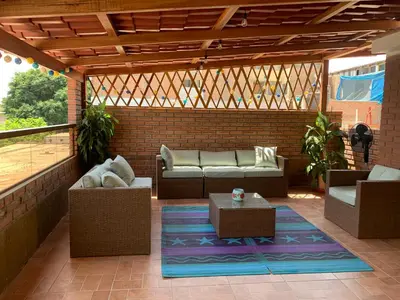 a patio with couches and tables on a brick wall at Lindo depa san miguel, 3camas, wifi, terraza. in Lima