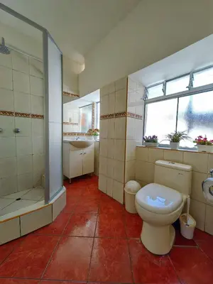 a bathroom with a toilet and a shower and a sink at Centro Cusco Inti Saphy in Cusco