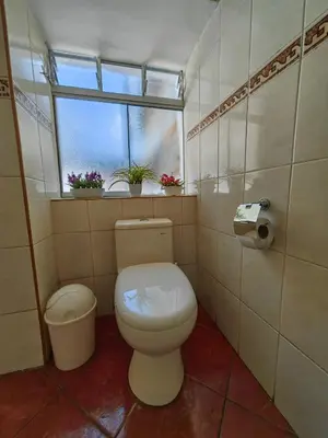 a small bathroom with a toilet and a window at Centro Cusco Inti Saphy in Cusco