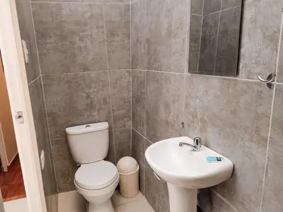 a bathroom with a toilet and a sink at Centro Cusco Inti Saphy in Cusco