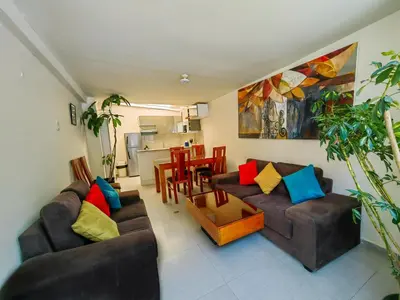 a living room with two couches and a table at Centro Cusco Inti Saphy in Cusco
