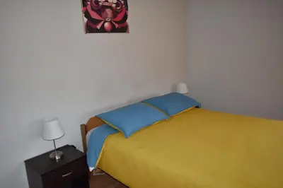 a bedroom with a bed and a picture on the wall at saga andina in Cusco