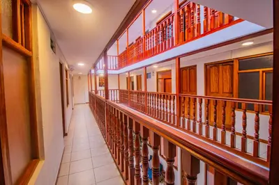 a hallway of a building with wooden railing at Munay Ñusta Cusco in Cusco