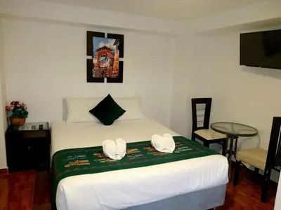 a hotel room with a bed with two hats on it at Munay Ñusta Cusco in Cusco