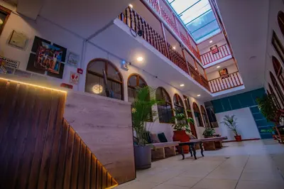 a hallway of a building with stairs and plants at Munay Ñusta Cusco in Cusco