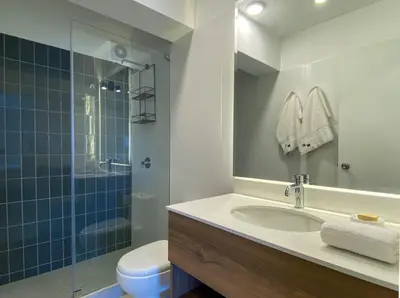 a bathroom with a sink and a shower and a toilet at Pod by Wynwood House in Lima