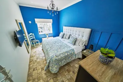 a blue bedroom with a bed and a table at Pucllana BBBoutique in Lima